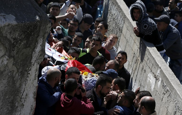 Mourners attend the funeral of a Palestinian man killed during clashes with Israeli security forces at the Qalandiya refugee camp on March 1, 2016 in the Israeli-occupied West Bank. (AFP / ABBAS MOMANI)