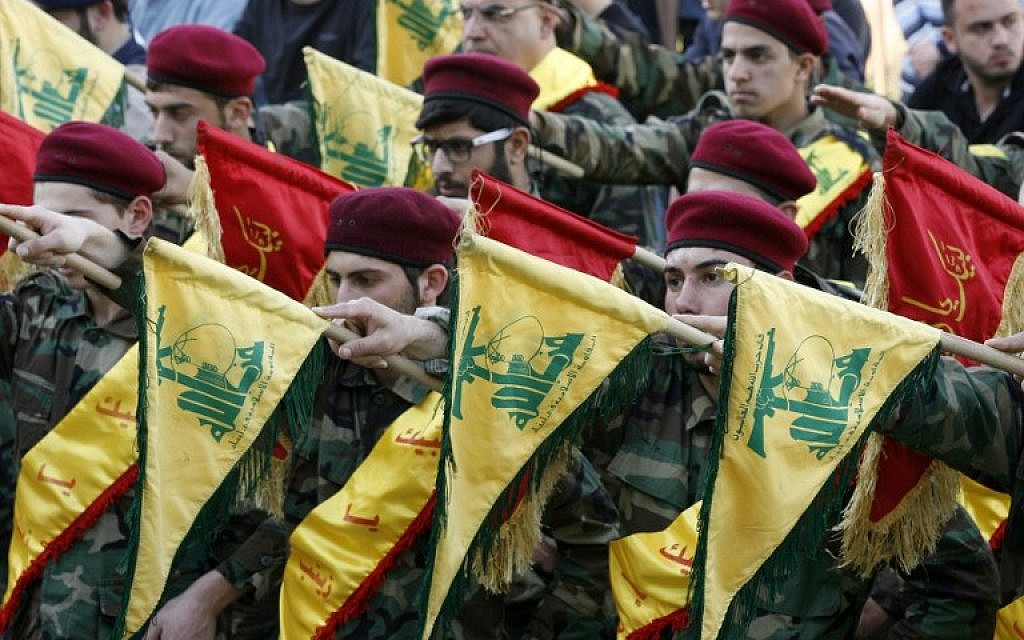 Members of Lebanon's Shiite Hezbollah hold their flags during the funeral of a Hezbollah fighter, who was killed while fighting alongside Syrian government forces in Syria, March 1, 2016. (AFP/Mahmoud Zayyat)