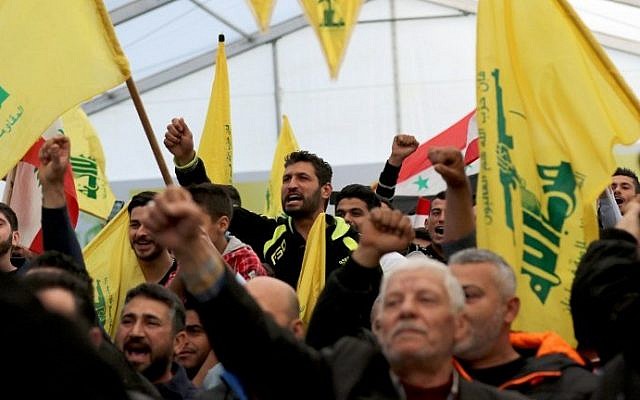 Supporters of Hezbollah chant slogans during a televised speech by leader Hassan Nasrallah in the southern town of Insar, Lebanon, on March 6, 2016. (AFP/Mahmoud Zayyat)