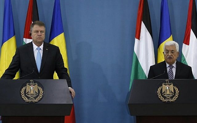 Palestinian Authority President Mahmoud Abbas (R) and Romanian President Klaus Iohannis during a joint press conference in the West Bank city of Ramallah on March 10, 2016. (AFP/Abbas MomaniI)