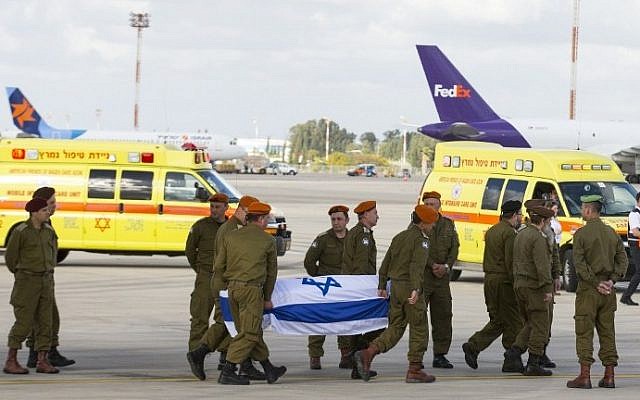 IDF soldiers carry the coffin of one of three Israelis killed a day earlier in an Istanbul suicide bombing, as the bodies of the victims arrive at Ben Gurion Airport on March 20, 2016. (AFP/Jack Guez)