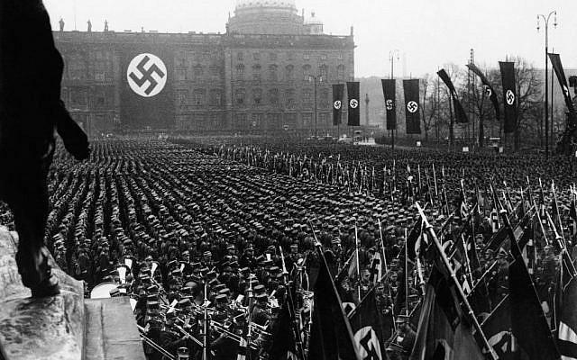 The Associated Press photographs the third anniversary of National Socialism's accession to power in 1933 widely celebrated throughout Germany on Feb. 11, 1936. At noon, Adolf Hitler assembled 25,000 of his oldest stormtroop comrades in the Lustgarten in Berlin. In his address, Hitler reiterated Germany’s will to peace. This is a general view of the banner and flag bearers in Berlin. (AP Photo)