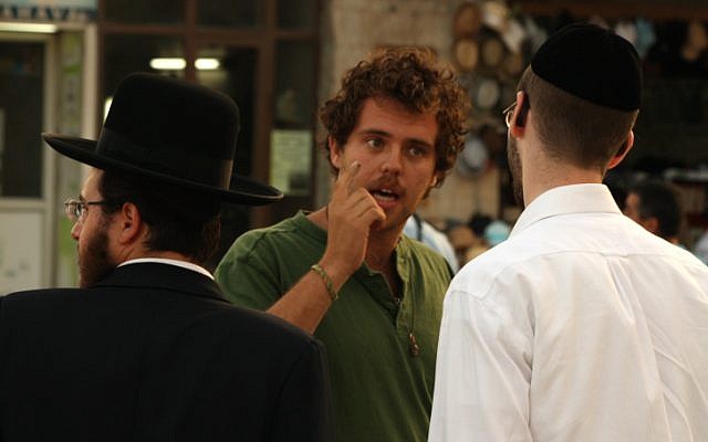 A secular Jew talks to an ultra-Orthodox man about the Green Line in front of City Hall in Jerusalem, June 5, 2013. (Lucie March/Flash 90)