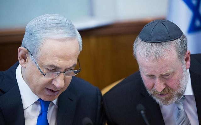 Prime Minister Benjamin Netanyahu, left, confers with then-cabinet secretary Avichai Mandelblit during a weekly cabinet meeting in Jerusalem, on December 20, 2015. (Yonatan Sindel/Flash90)