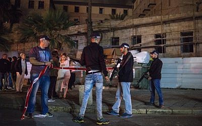 Israeli police and medics at the scene of a stabbing attack in Jaffa where one person was killed and 11 others were wounded on March 8, 2016. (Matanya Tausig/Flash90)