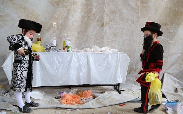 Ultra-Orthodox Jewish kids dress up in costumes as they celebrate the Jewish holiday of Purim, in Beit Shemesh, on March 24, 2016. (Yaakov Lederman/Flash90)