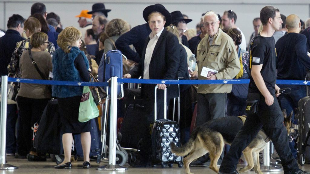 An Israeli airport security guard patrols with a dog in Ben Gurion airport near Tel Aviv, Israel, Tuesday, March 22, 2016. (AP Photo/Ariel Schalit) 