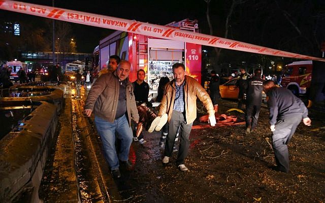 People carry an injured person after an explosion in the busy center of Turkish capital, Ankara, Turkey, Sunday, March 13, 2016. (AP)
