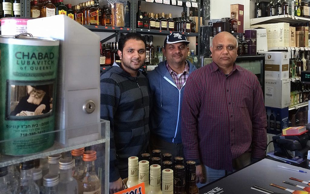Samir Patel, left, with an associate and his father, right, says he gets about five requests each Saturday to act as a 'Shabbos goy' for Orthodox Jews. (Uriel Heilman)