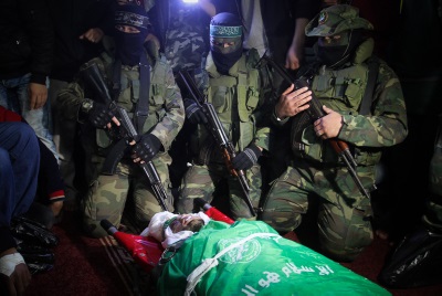 Palestinian members of the Ezzedine al-Qassam Brigades, seen near the body of Marwan Maarouf, 27, during his funeral in Khan Yunis in the southern Gaza Strip, on February 9, 2016. Maarouf was killed when a tunnel collapsed in the Gaza Strip. Photo by Abed Rahim Khatib/Flash90.
