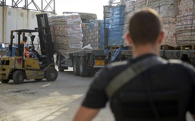 Illustrative. Defense Ministry contractors monitor the transfer of supplies and goods into the Gaza Strip through the Kerem Shalom Crossing on July 19, 2014. (Israel Defense Forces)