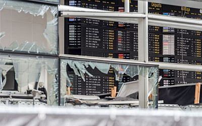 An arrivals and departure board is seen behind blown out windows at Zaventem Airport in Brussels, March 23, 2016. (AP/Geert Vanden Wijngaert, Pool)