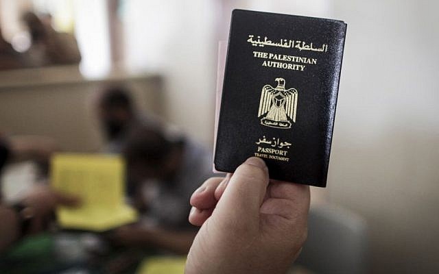 A Palestinian man at the Rafah border crossing holds his Palestinian Authority issued passport  on June 12, 2015. (Aaed Tayeh/Flash90)