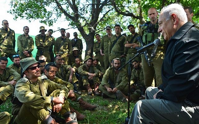 Prime Minister Benjamin Netanyahu meets with Israeli soldiers in the Golan Heights during a tour of the area on April 11, 2016. (Kobi Gideon/GPO)