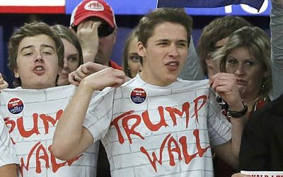 Supporters of Republican presidential candidate Donald Trump chant 'Build That Wall' before a town hall Saturday, April 2, 2016, in Rothschild, Wisconsin. (AP Photo/Charles Rex Arbogast)