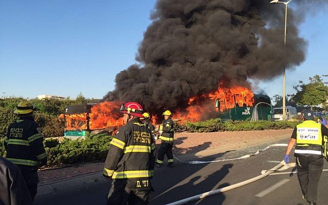 Firefighters look on as two buses burn in Jerusalem after a bombing on April 18, 2016. (Israel Police)