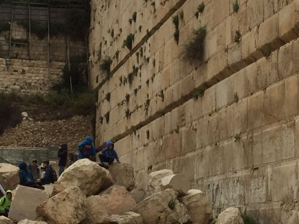 Kids play on 2,000-year-old building stones in Jerusalem's Old City Davidson Archeology Park, on April 12, 2016. (Amanda Borschel-Dan/The Times of Israel)