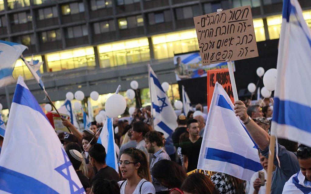 Protesters gather in Tel Aviv's Rabin Square in support of a soldier on trial for killing a Palestinian attacker in March who was incapacitated, on April 19, 2016. (Judah Ari Gross/Times of Israel staff)