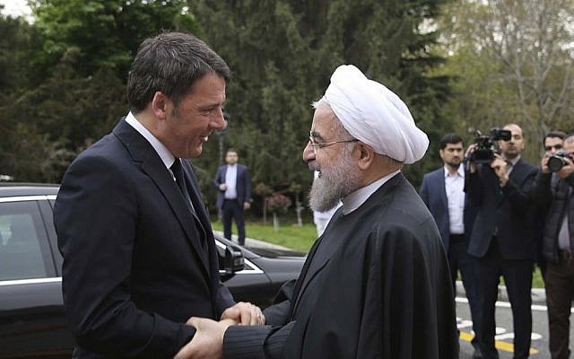 Iran's President Hassan Rouhani welcomes Italian Prime Minister Matteo Renzi during an official arrival ceremony at the Saadabad Palace in Tehran, Iran, April 12, 2016. (Iranian Presidency Office via AP)