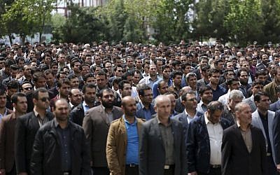 In this picture made available by Young Journalists Club, YJC, on Monday, April 18, 2016, Iranian plainclothes police officers stand in an inauguration ceremony of a newly established undercover division of the morality police, at the Tehran police department, Iran. (AP Photo/YJC, Mohammad Ali Najib) 