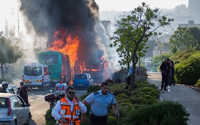 Firefighters and rescue personnel at the scene of a suicide bus bombing in Jerusalem, in which 20 people were wounded, on April 18, 2016, (Nati Shohat/Flash90)