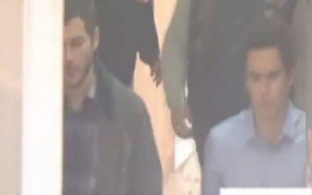 David Geclowitz and Ron Weiner, employees of the Israeli private intelligence firm Black Cube, being brought to the appeals court in Bucharest, after their arrest on suspicion of spying on the country's chief anti-corruption persecutor, April 12, 2016. (Screenshot: Channel 2)