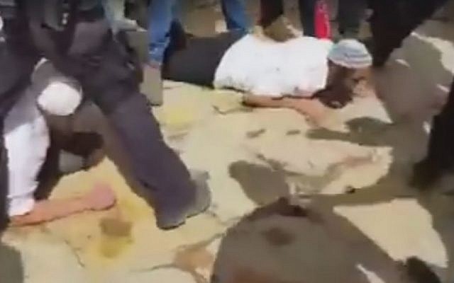 Jewish visitors to the Temple Mount prostrated themselves in prayer in violation of Israeli regulations on April 26, 2016. (screen capture: Twitter)