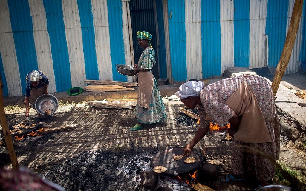 Women of Gondar's Jewish community prepare matzah before Passover on April 20, 2016. The matzah must stay on the fire for less than 10 minutes, so it is cooked in less than 18 minutes and is kosher for Passover. (Miriam Alster/Flash90)