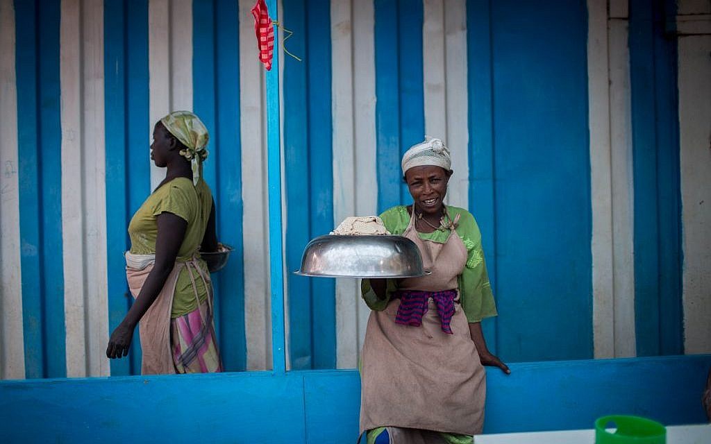 A woman waits to bring matzah dough to the fires in Gondar, Ethiopia on April 20, 2016. (Miriam Alster/Flash90)