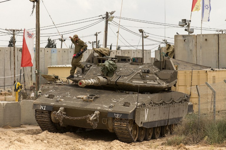 An Israeli soldier atop his tank on the border between Israel and the Gaza Strip on May 6, 2016 (AFP PHOTO / JACK GUEZ)