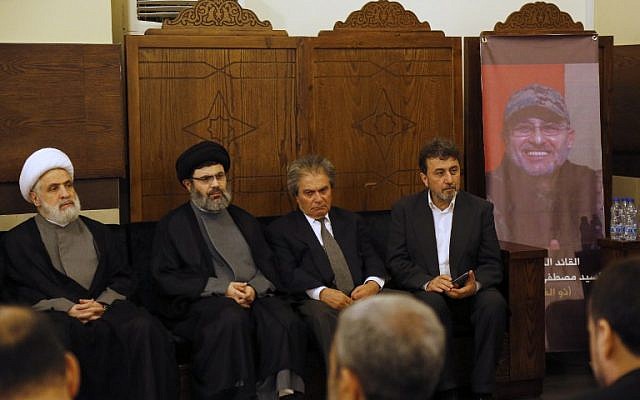 (From L-R) Lebanese Hezbollah deputy chief Sheikh Naim Qassem, head of the Hezbollah Executive Council Sayyed Hashem Safieddine, and the brothers, Annan Badreddine and Hassan Badreddine, of top Hezbollah commander Mustafa Badreddine who was killed in an attack in Syria, receive condolences in a southern suburb of Beirut, on May 13, 2016. (AFP PHOTO / ANWAR AMRO)