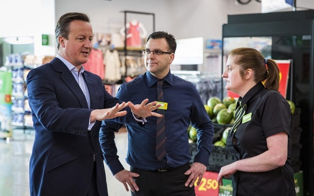 British Prime Minister David Cameron (L) speaks to employees as they visit a supermarket in west London on May 22, 2016 (AFP PHOTO / POOL / JACK TAYLOR)