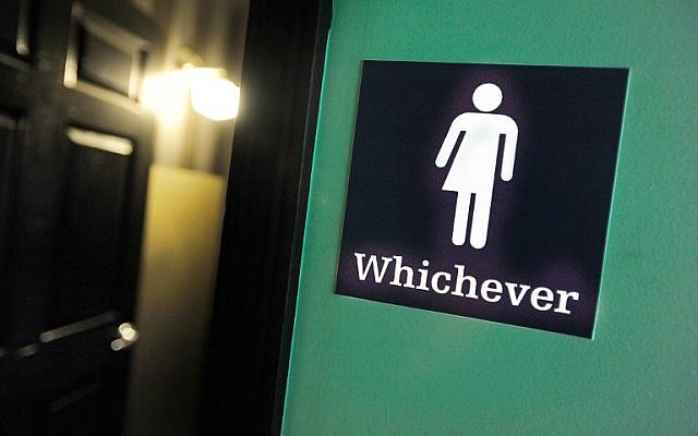 A gender neutral sign is posted outside a bathrooms at Oval Park Grill on May 11, 2016 in Durham, North Carolina. (Sara D. Davis/Getty Images/AFP)