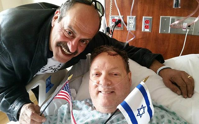 Hany Baransi (left) visits Bill Foley in hospital. Foley was seriously injured in a machete attack on Baransi's restaurant in Columbus, Ohio on February 11, 2016. (Courtesy)