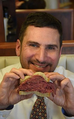 Ted Merwin, Associate Professor of Religion and Judaic Studies at Dickinson College in Pennsylvania, and author of 'Pastrami on Rye: An Overstuffed History of the Jewish Deli,' holds the book's title dish -- pastrami on rye (Curt Hudson)
