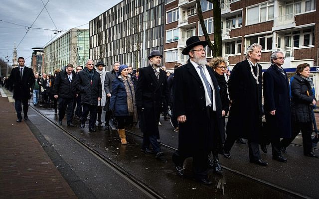Illustrative: Mayor of Amsterdam Eberhard van der Laan (4th R) leads a march from City Hall to the Auschwitz monument in the Wertheimpark in Amsterdam on January 26, 2014, during the national memorial day for the victims of the Holocaust. (AFP Photo/ANP/Remko de Waal via JTA)