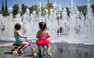 Children play in a water fountain near the Old City's Tower of David, Jerusalem, on April 17, 2016. (Corinna Kern/Flash90)