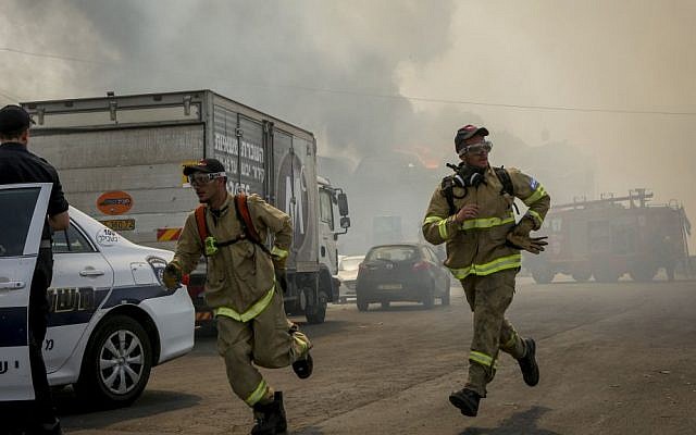 Firefighters at the scene of a large fire that broke at a warehouse in Jerusalem's Givat Shaul neighborhood on May 16, 2016. (Shlomi Cohen/Flash90)