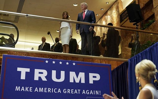Donald Trump, accompanied by his wife, Melania, is applauded by his daughter Ivanka (right) as he's introduced before his announcement that he will run for president in the lobby of Trump Tower in New York, June 16, 2015. (AP/Richard Drew, File)