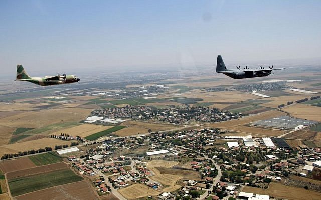 A C-130J Super Hercules and a C-130 Hercules fly over Israel as part of the Israeli Air Force's annual flyby on Independence Day, May 12, 2016. (Judah Ari Gross/Times of Israel)