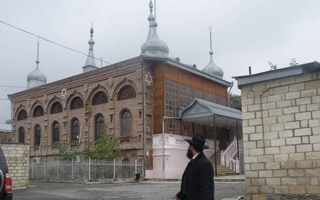 Rabbi Yona Yaakobi stands in front of the larger synagogue currently active in the Jewish Azerbaijani town of Krasnaya Sloboda. (Courtesy)