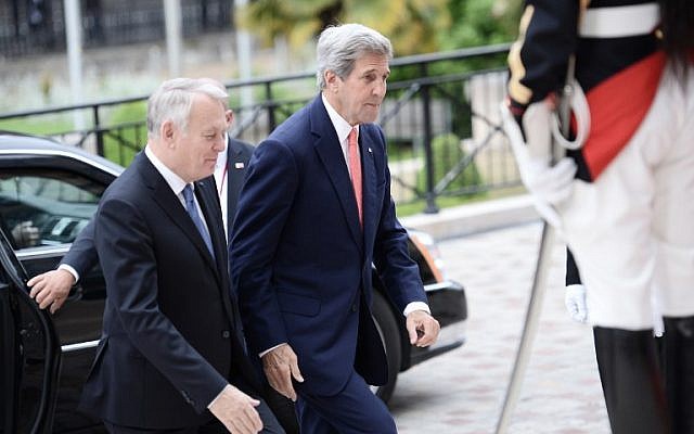 French Foreign Minister Jean-Marc Ayrault (left) welcomes US Secretary of State John Kerry (right) upon his arrival for the international meeting in a bid to revive the Israeli-Palestinian peace process, in Paris, on June 3, 2016. (AFP/Stephane de Sakutin/Pool)