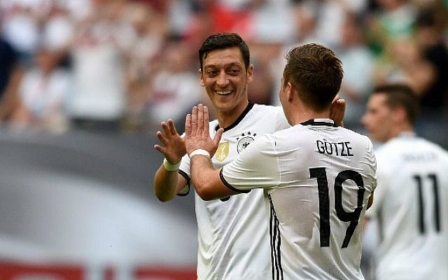 German player Mesut Ozil, left, and Mario Goetze celebrate after Goetze's goal vie during the UEFA EURO 2016 friendly football match Germany vs. Hungary at the Veltins Arena in Gelsenkirchen, western Germany, on June 4, 2016. (Patrik Stollarz/AFP)