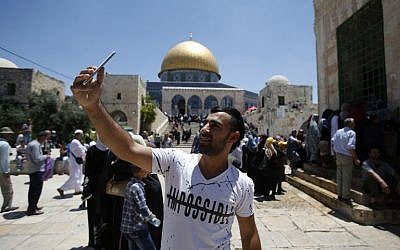 A Palestinian Muslim worshiper takes a selfie near the Dome of the Rock on the Temple Mount in Jerusalem on June 17, 2016, during Friday prayers in the holy fasting month of Ramadan. (AFP Photo/Ahmad Gharabli)