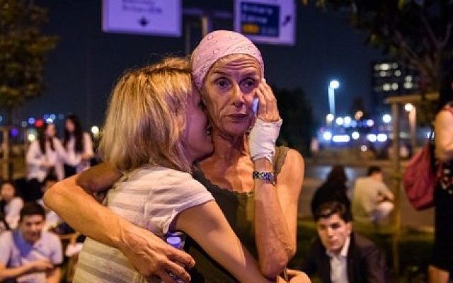 Passengers embrace outside Ataturk airport`s main entrance in Istanbul, on June 28, 2016, after a suicide attack left at least 36 people dead.  (AFP/ OZAN KOSE)