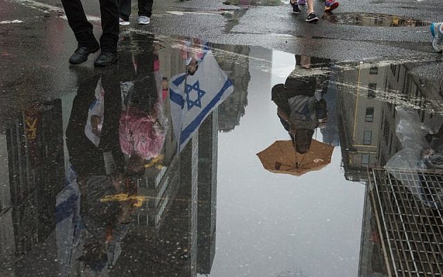 People participate in the Celebrate Israel Parade in the rain on June 5, 2016 in New York City (Stephanie Keith/Getty Images/AFP)