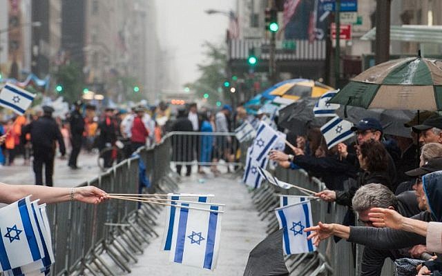 People participate in the Celebrate Israel Parade in the rain on June 5, 2016 in New York City (Stephanie Keith/Getty Images/AFP)