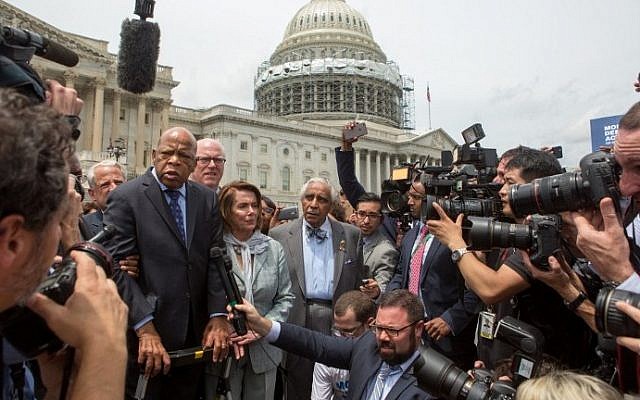 Rep. John Lewis (D-GA), left, Minority Leader Nancy Pelosi (D-CA), center, and Charles Rangel, (D-NY), right, speak with supporters outside the U.S. Capitol building June 23, 2016. (Allison Shelley/Getty Images/AFP)