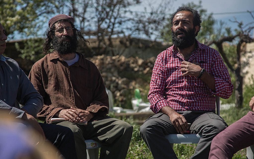 An Israeli settler and Palestinian sit with the Fact Finders group at the Roots tent near Gush Etzion and discuss peace and coexistence