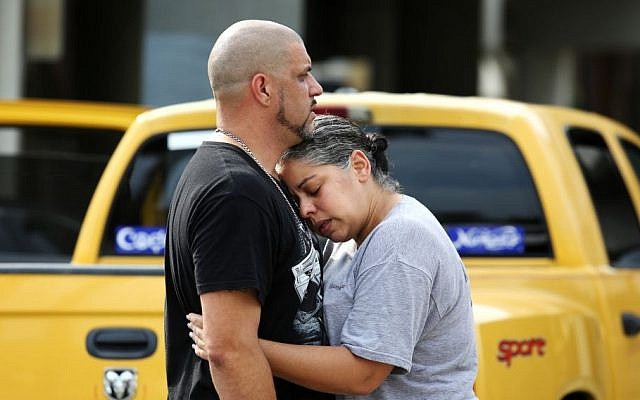 Ray Rivera, left, a DJ at Pulse Orlando nightclub, is consoled by a friend, outside of the Orlando Police Department after a shooting involving multiple fatalities at the nightclub, Sunday, June 12, 2016, in Orlando, Fla. (Joe Burbank/Orlando Sentinel via AP)